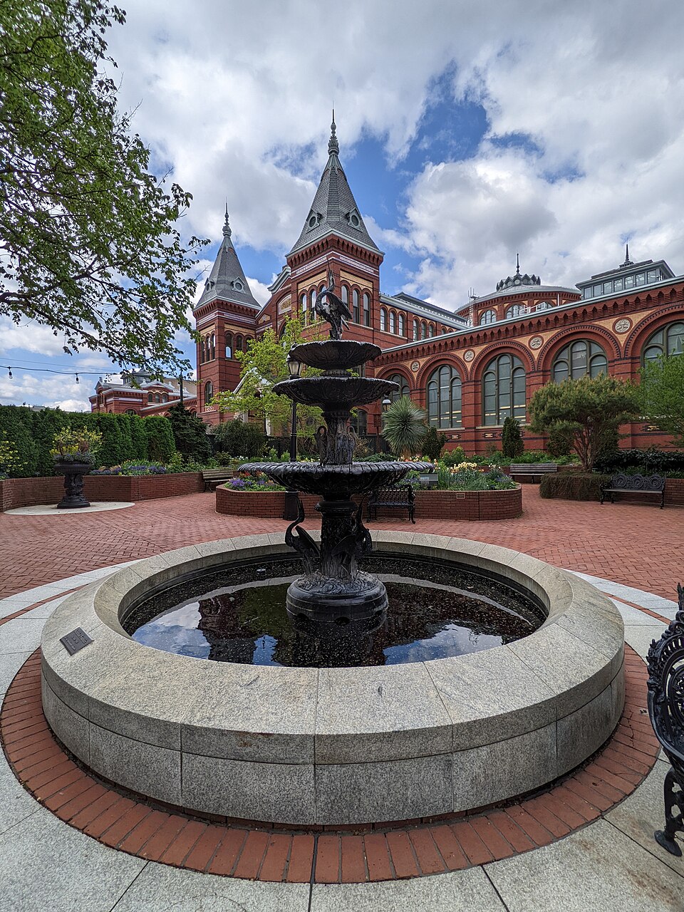 The Smithsonian Arts and Industries Building stands behind a fountain on the National Mall