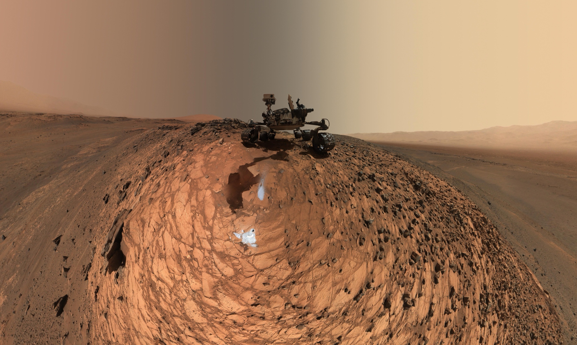 Curiosity rover on rocky Martian terrain in a low-angle 2015 mosaic made at the Buckskin drilling site on lower Mount Sharp