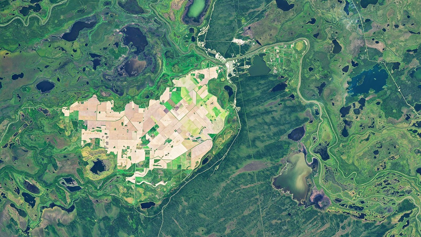 Landsat 8 view from September 21, 2026, showing rectangular tan, brown and green fields in Manitoba's Carrot River Valley surrounded by winding waterways, marshes and lakes.