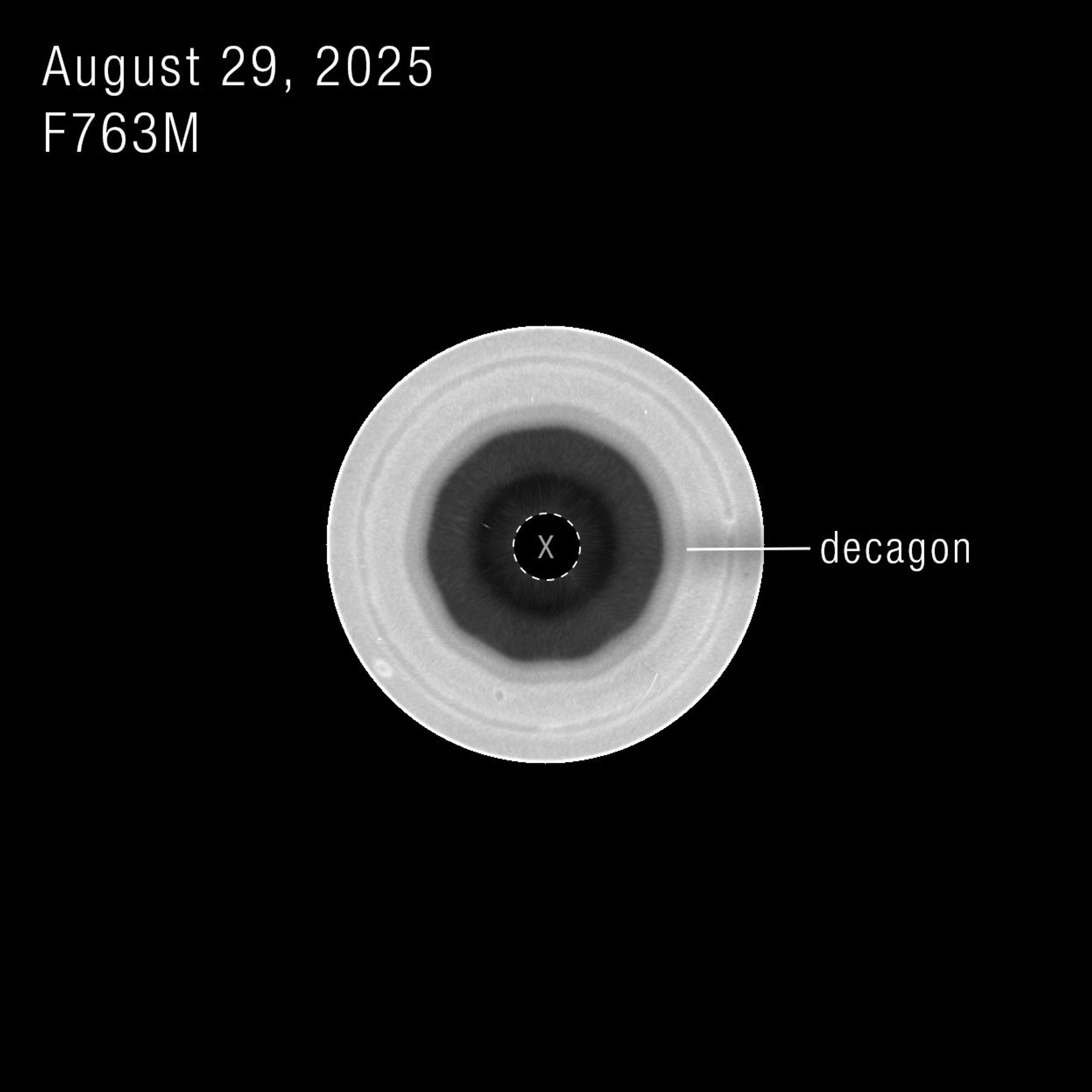 A filtered Hubble view of Saturn's south pole with the ten-sided wave labeled around the dark central region