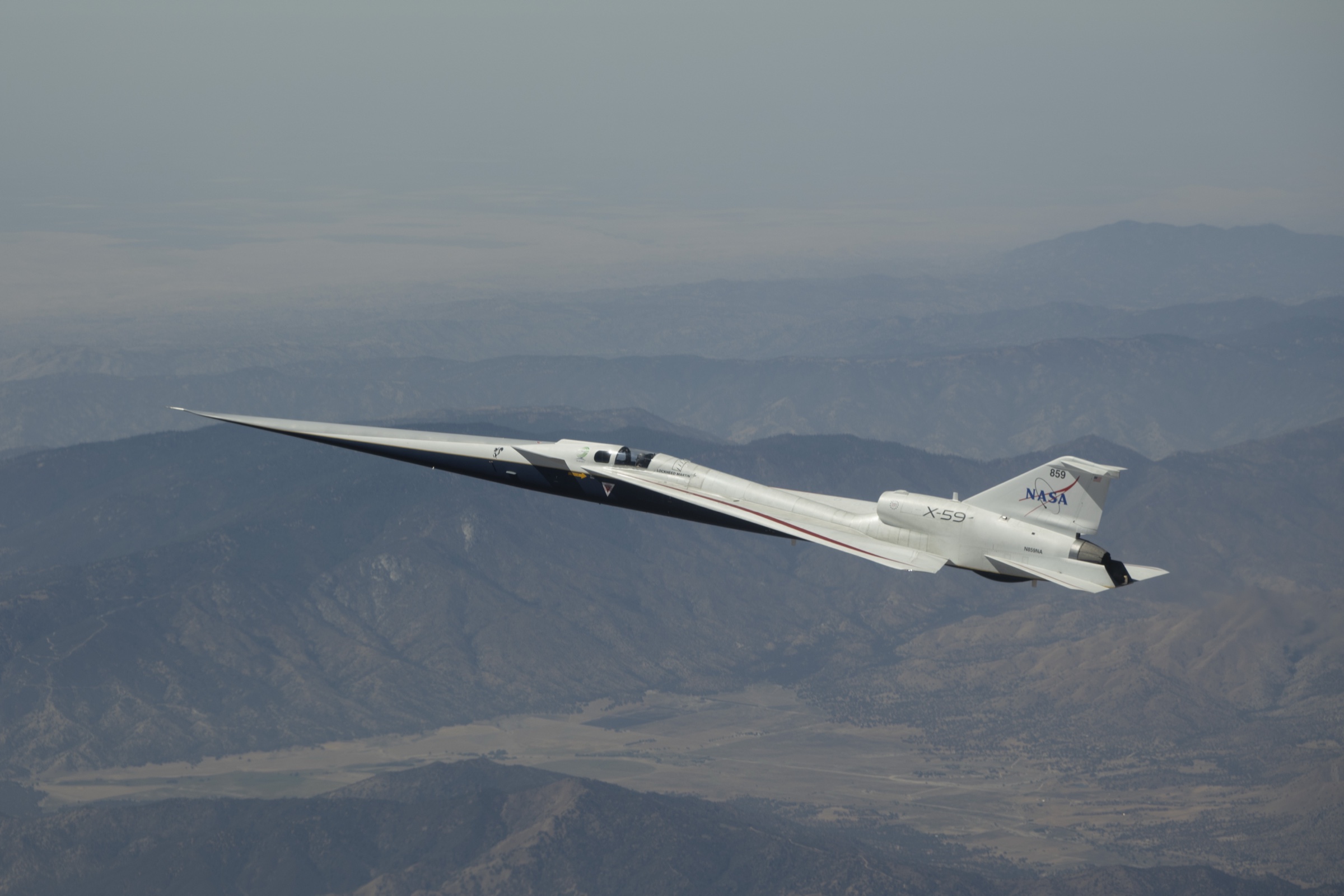 NASA's long, narrow X-59 experimental aircraft flying above California's Mojave Desert